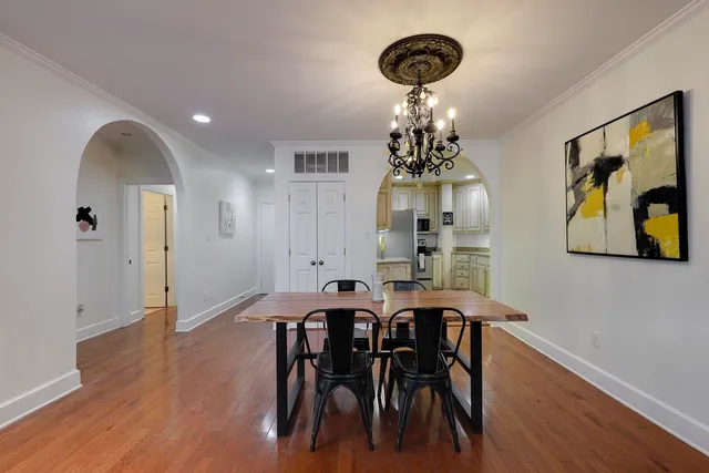 a view of a dining room with furniture wooden floor and chandelier