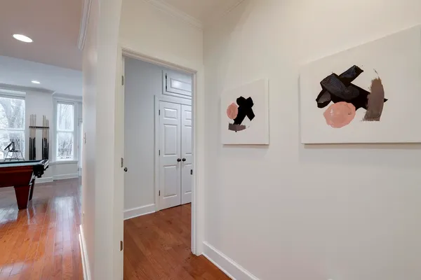 a view of a hallway with wooden floor and workspace