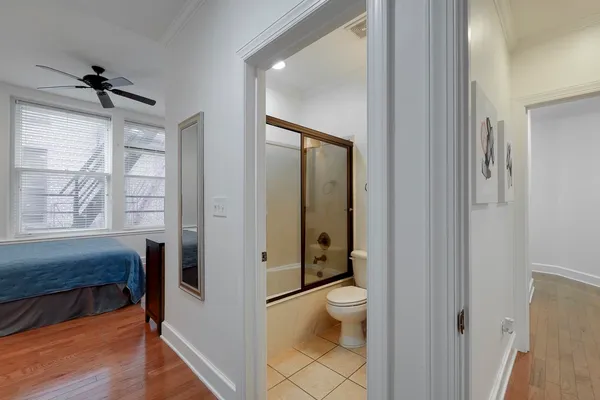 a bathroom with a granite countertop toilet a sink and a large mirror