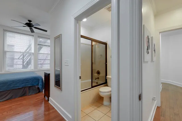 a bathroom with a granite countertop toilet a sink and a large mirror