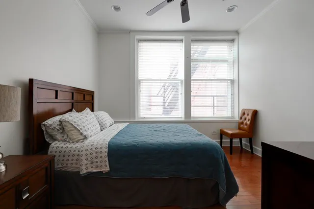 a bedroom with a bed and wooden floor