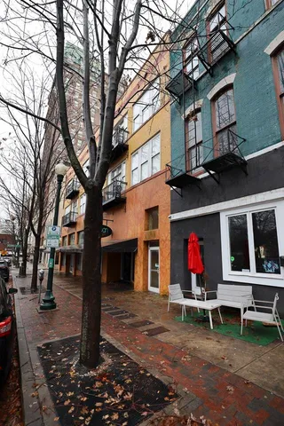 a view of house with a backyard