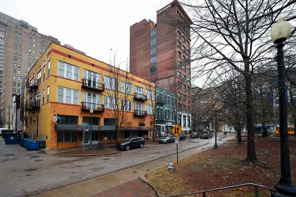 a city street lined with buildings and cars
