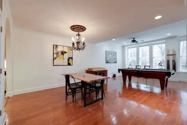 a living room with furniture a table and wooden floor