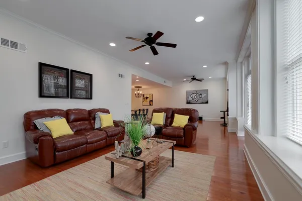 a living room with furniture and a ceiling fan