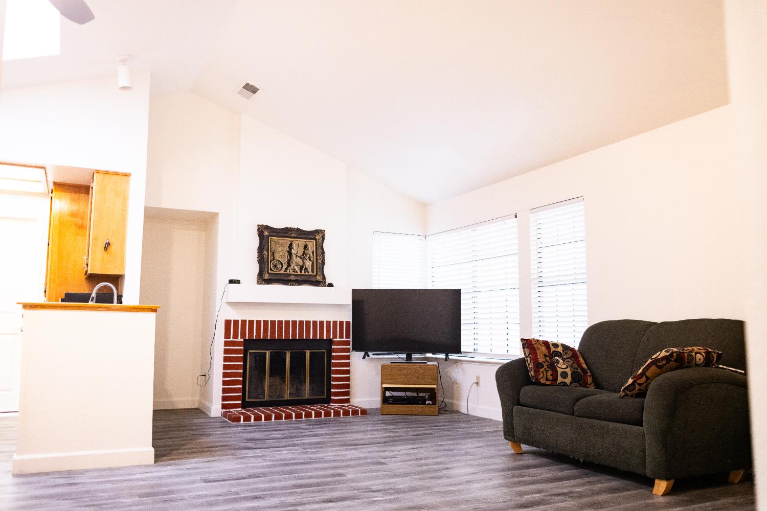 2263 Sandcastle Way Sacramento, CA 95833 - Photo 7 of 23 a living room with furniture a flat screen tv and a fireplace