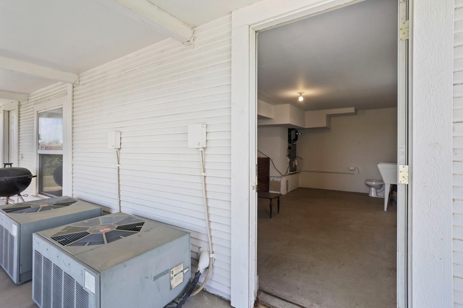 15370 Andrus Island Road Isleton, CA 95641 - Photo 45 of 67 Outside the smaller, separate storage room with a wash sink and a water closet. Two separate HVAC compressors tor each of the second and third floors. The storage rooms are unconditioned.