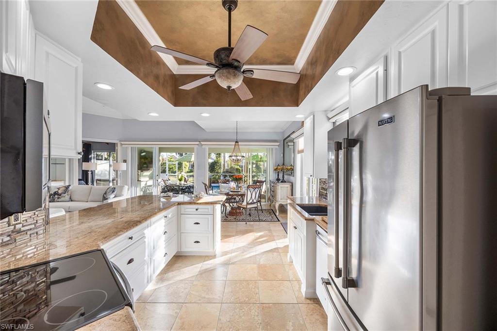 7534 Garibaldi Court Naples, FL 34114 - Photo 11 of 50 a kitchen with stainless steel appliances granite countertop a refrigerator and a sink