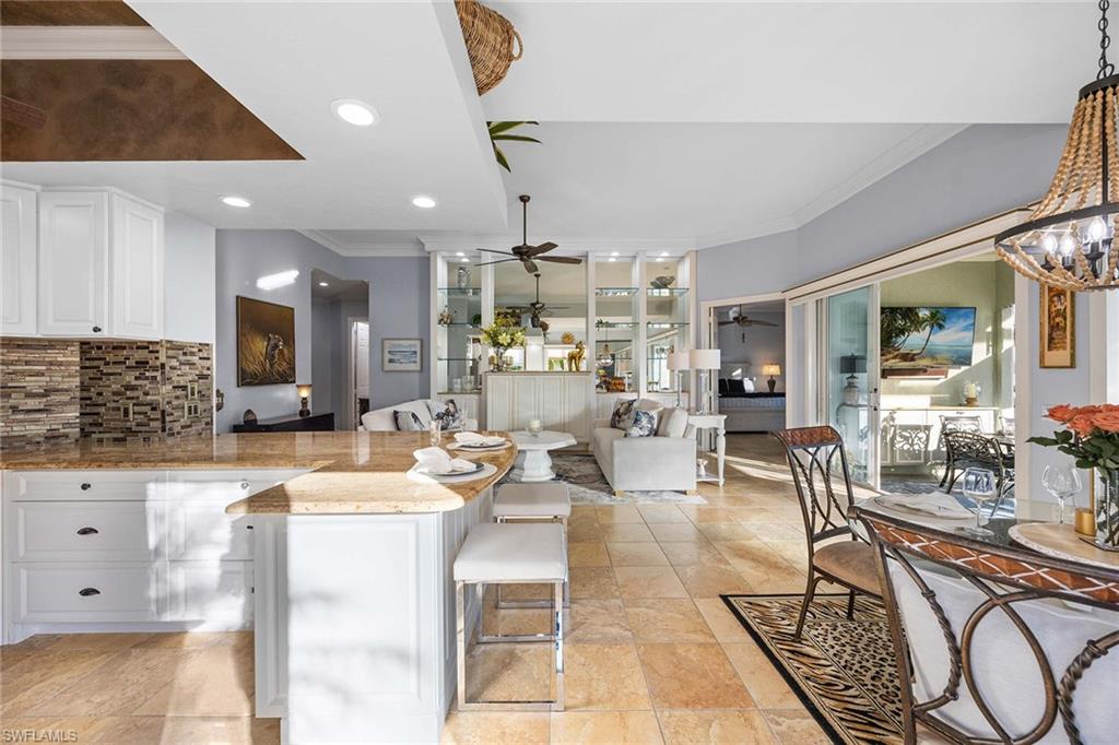 7534 Garibaldi Court Naples, FL 34114 - Photo 12 of 50 a living room with fireplace furniture and a rug