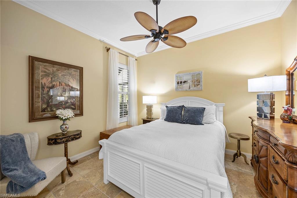 7534 Garibaldi Court Naples, FL 34114 - Photo 19 of 50 a bedroom with a bed and a chandelier