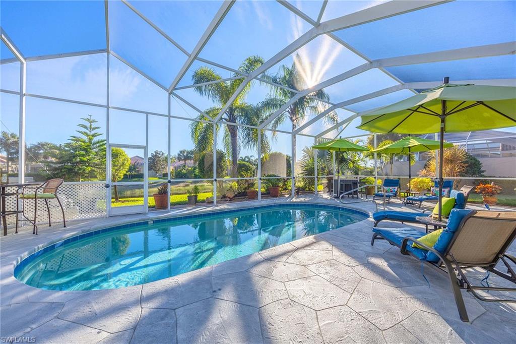 7534 Garibaldi Court Naples, FL 34114 - Photo 2 of 50 a view of a swimming pool with sitting area