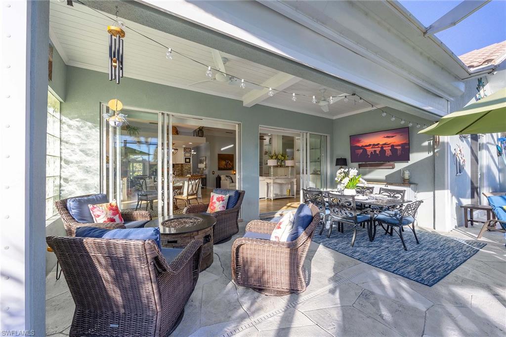 7534 Garibaldi Court Naples, FL 34114 - Photo 27 of 50 a living room with furniture and a large window