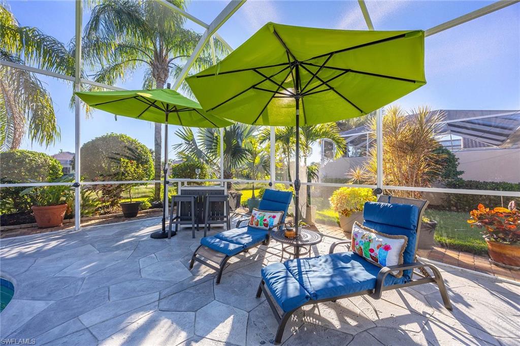 7534 Garibaldi Court Naples, FL 34114 - Photo 31 of 50 a view of a table and chairs under an umbrella in the patio