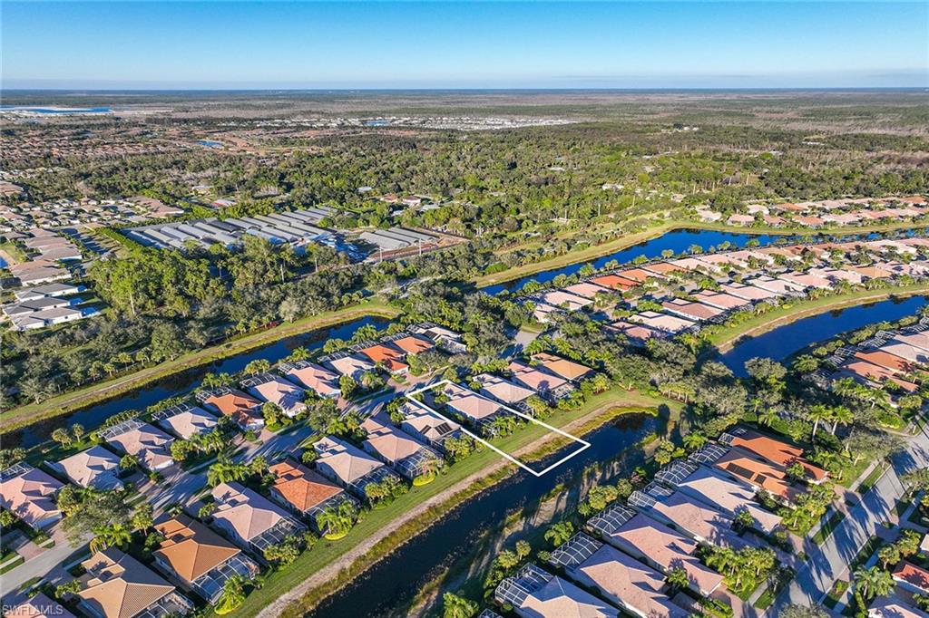 7534 Garibaldi Court Naples, FL 34114 - Photo 36 of 50 an aerial view of residential houses with outdoor space