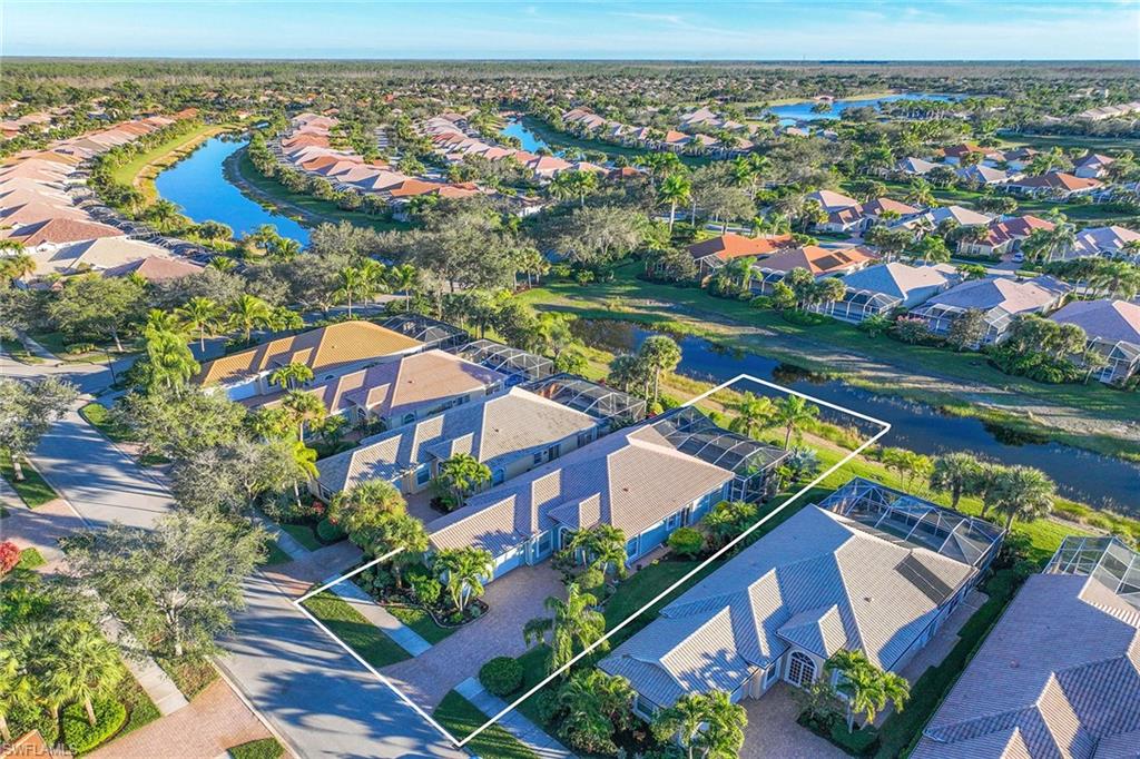 7534 Garibaldi Court Naples, FL 34114 - Photo 37 of 50 an aerial view of a house with a lake view