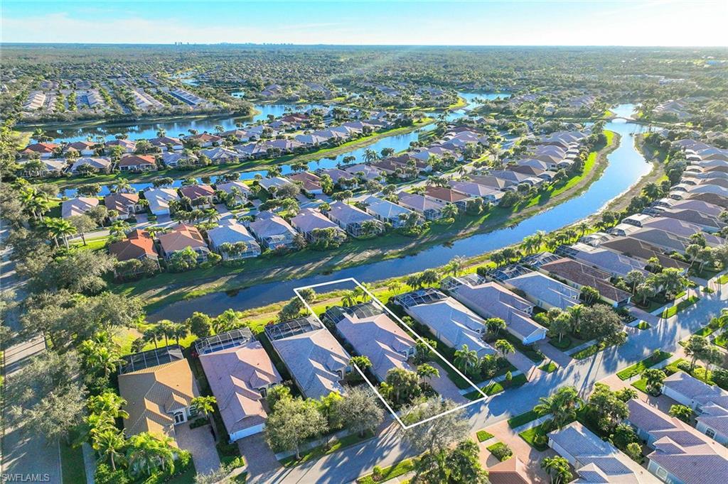 7534 Garibaldi Court Naples, FL 34114 - Photo 38 of 50 an aerial view of residential houses with outdoor space and swimming pool