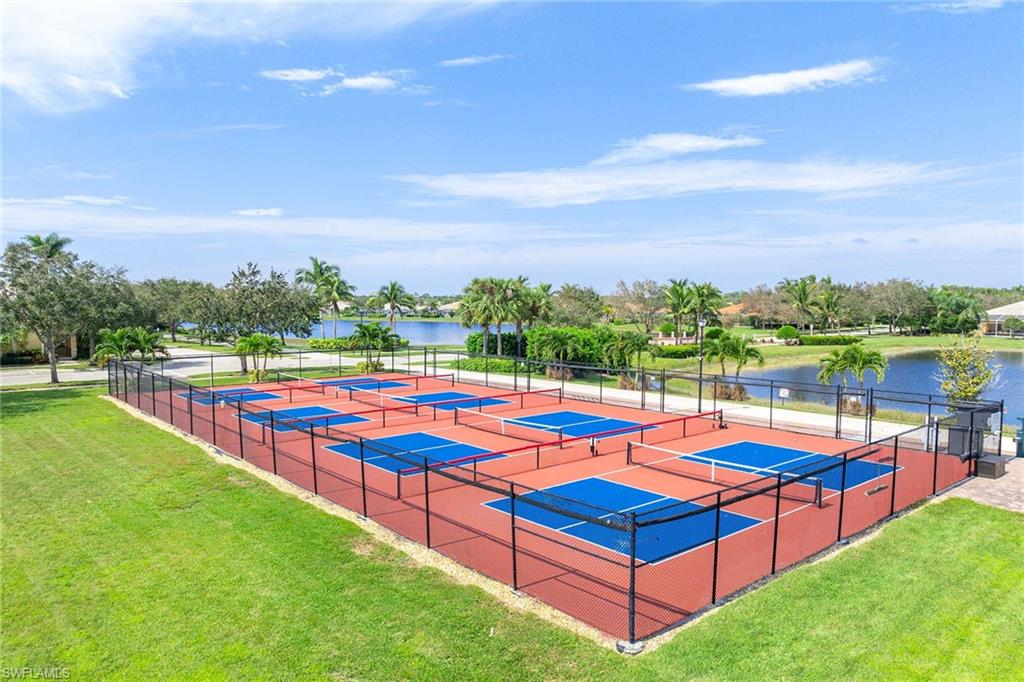 7534 Garibaldi Court Naples, FL 34114 - Photo 45 of 50 a view of swimming pool with lounge chairs in a park