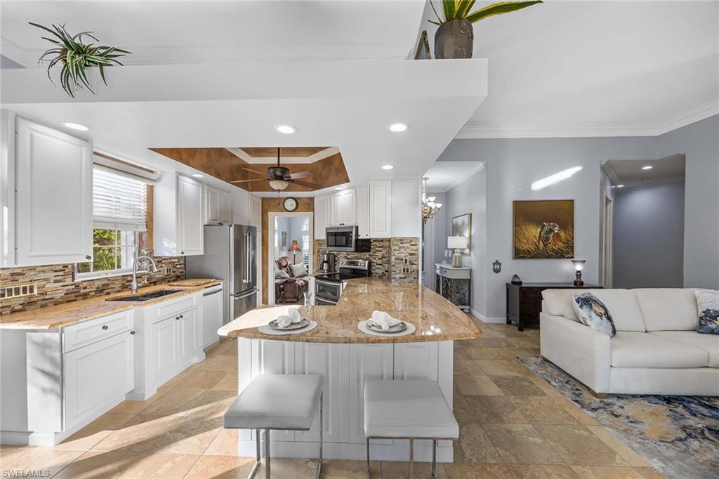 7534 Garibaldi Court Naples, FL 34114 - Photo 50 of 50 a large kitchen with a table and chairs