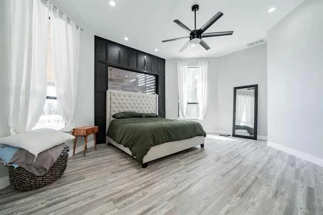 a bedroom with a bed and a large window