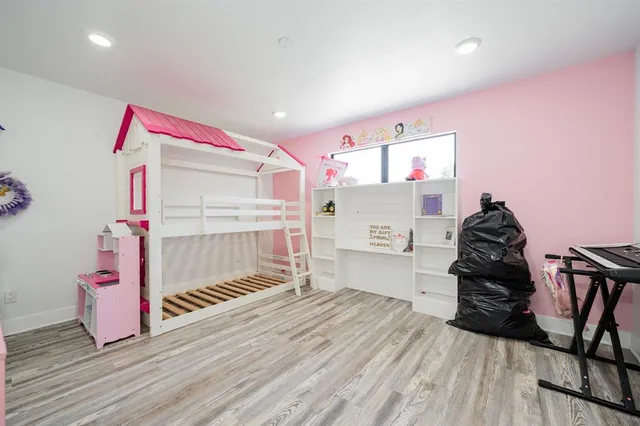 a bedroom with furniture and wooden floor