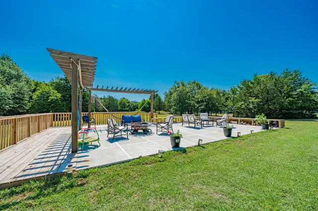 a view of a chairs and table in the back yard