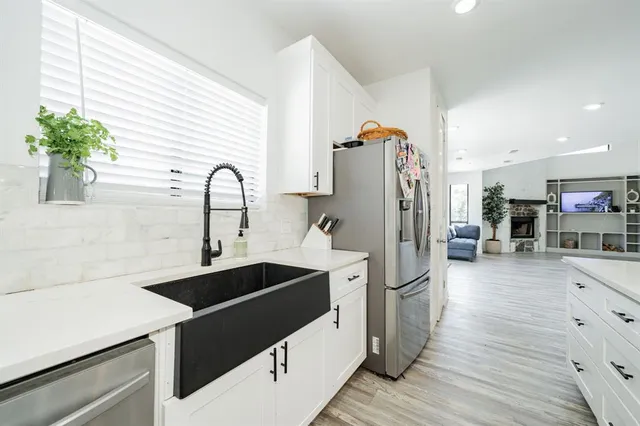 a kitchen with stainless steel appliances a sink stove and refrigerator