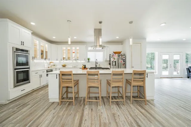 a large kitchen with a table and chairs