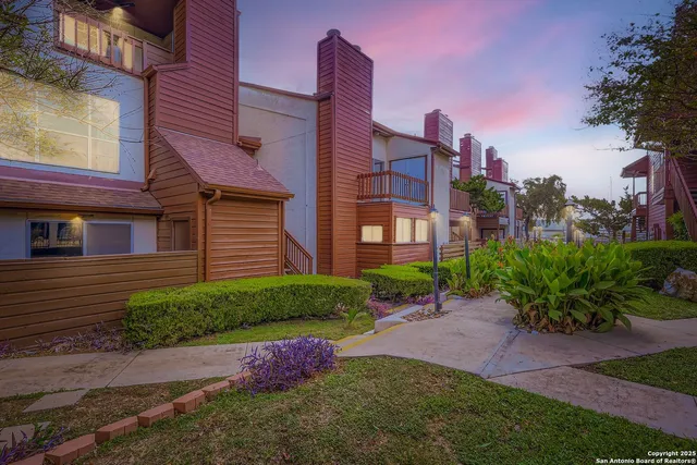 a pathway of a house with a yard