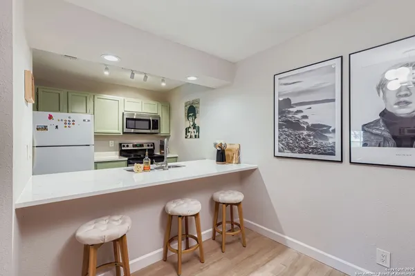 a kitchen with stainless steel appliances a refrigerator and microwave