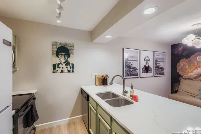a kitchen with a sink a stove and a refrigerator