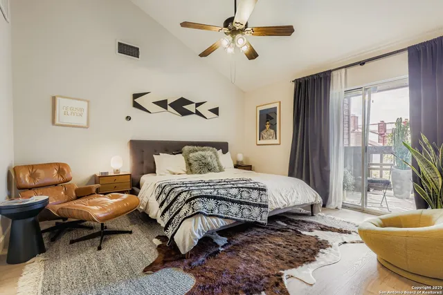 a bedroom with a bed a couch and a window