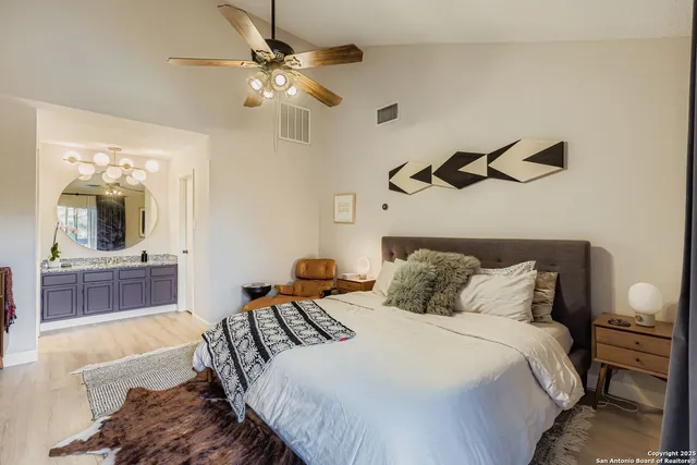 a bedroom with a bed and ceiling fan