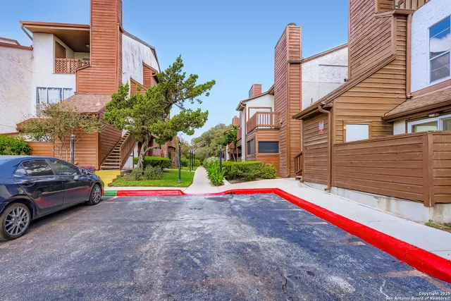 a view of a house with a small yard and sitting area
