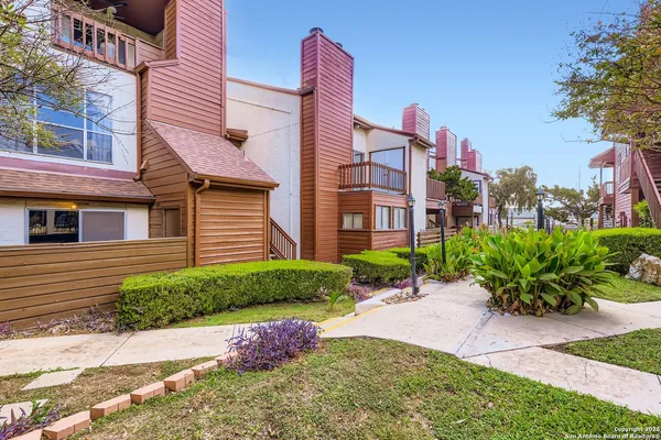 a front view of a house with a yard and outdoor seating