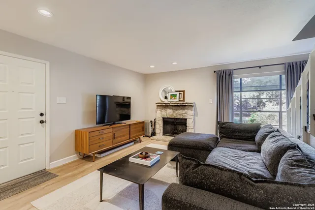 a living room with furniture and a fireplace