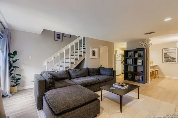 a living room with furniture and wooden floor