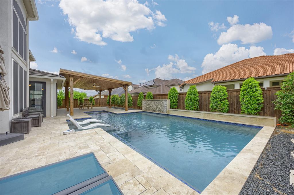 918 Sydney Lane Allen, TX 75013 - Photo 32 of 40 This property features a swimming pool with an integrated waterfall and an expansive patio