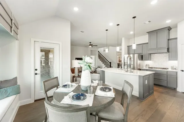 a kitchen with a dining table chairs stove and kitchen view