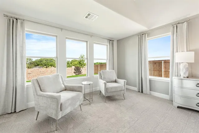 a living room with furniture and windows