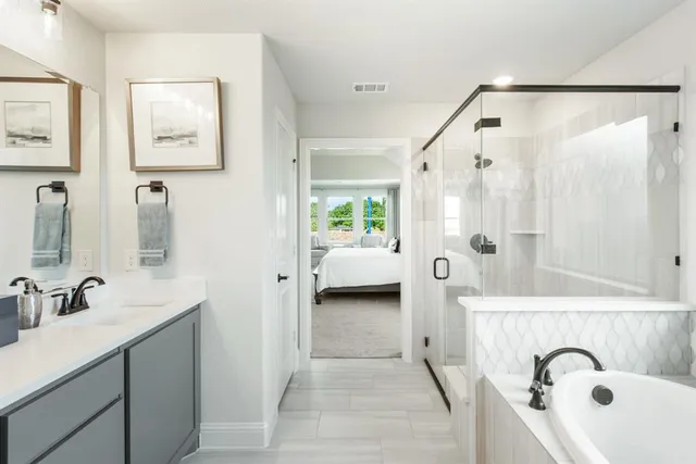 a en suite spacious bathroom with a shower sink and mirror