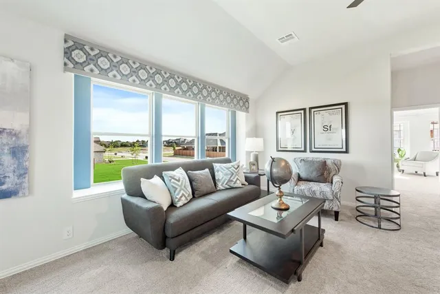 a living room with furniture and a large window