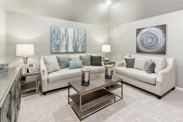 a living room with furniture and a wall painting