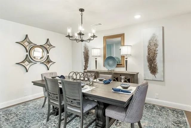 a view of a dining room with furniture wooden floor and a chandelier