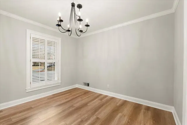 a view of a room with wooden floor and windows