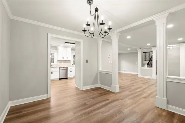 a view of a kitchen with a refrigerator and a stove top oven