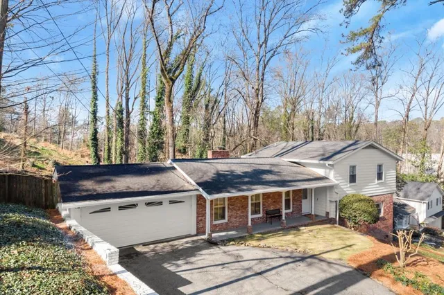 a view of a white house next to a yard