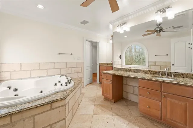a bathroom with a granite countertop sink mirror and bathtub
