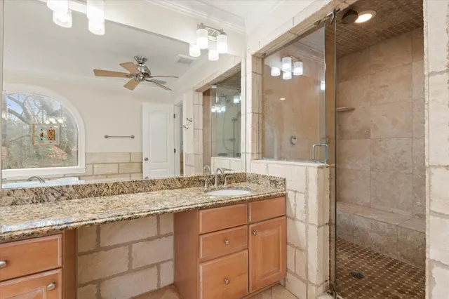 a bathroom with a granite countertop sink mirror and