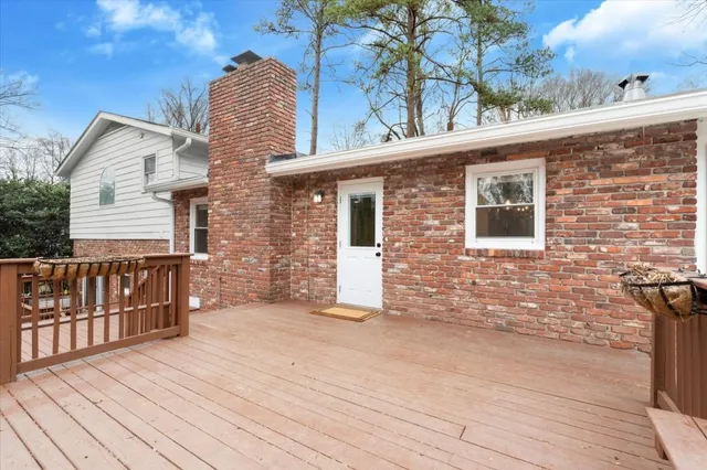a view of a house with a barbeque and wooden stairs