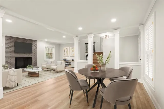 a view of a dining room with furniture and wooden floor